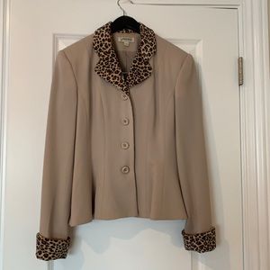 Beautiful Italian 100%wool suit with mini skirt. Has leopard collar and cuffs.
